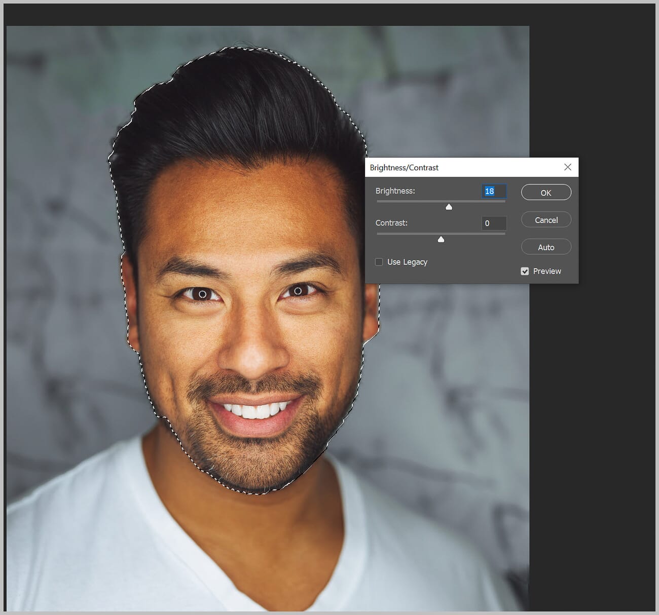 Brightness increased on a selected person's face in Photoshop