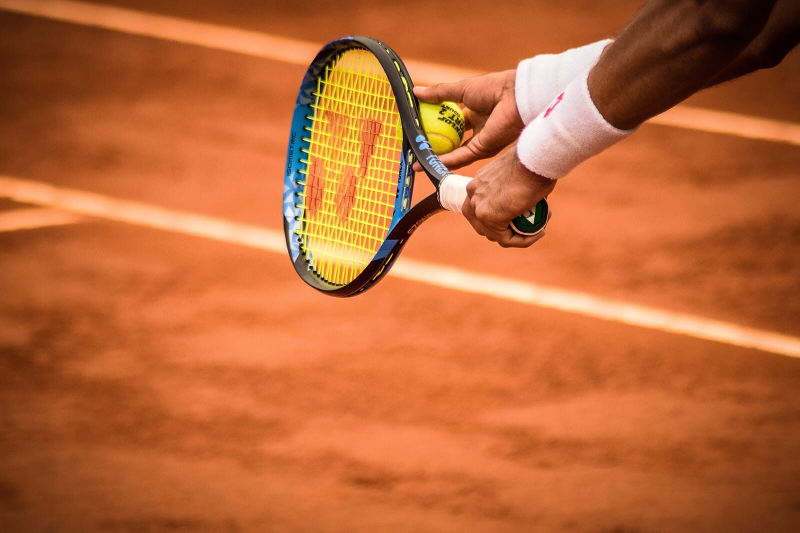 Tennis player preparing to serve the ball