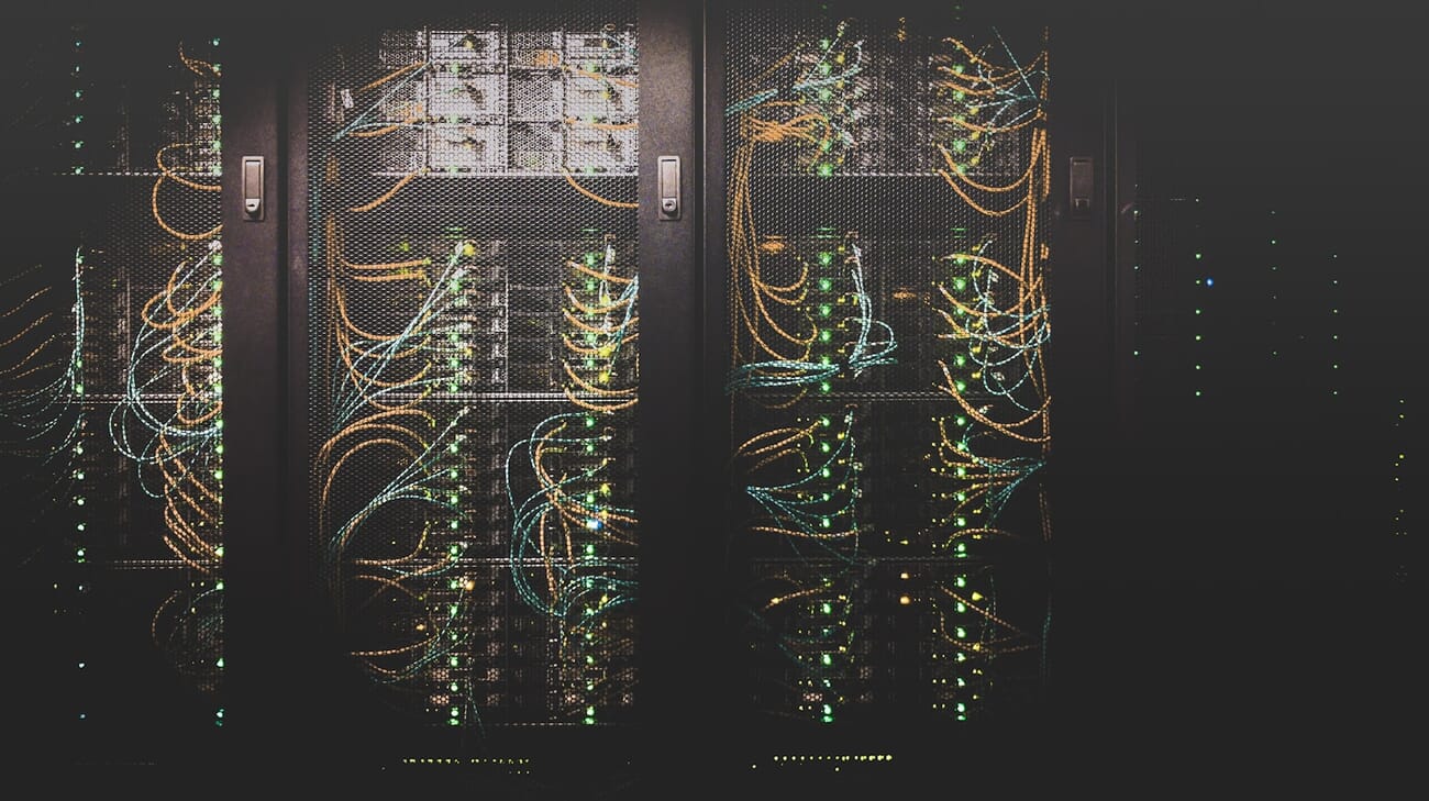 Data center server room with illuminated racks and network cables