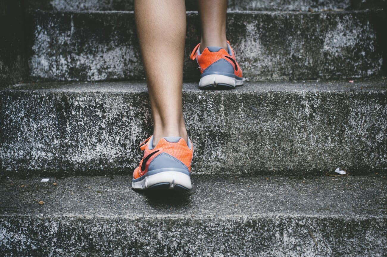 Street photography of a person walking up stairs - lifestyle content popular on free stock photo sites