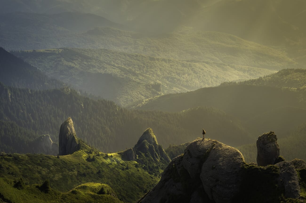 Mountain landscape bathed in warm golden hour light with long shadows and rich warm tones