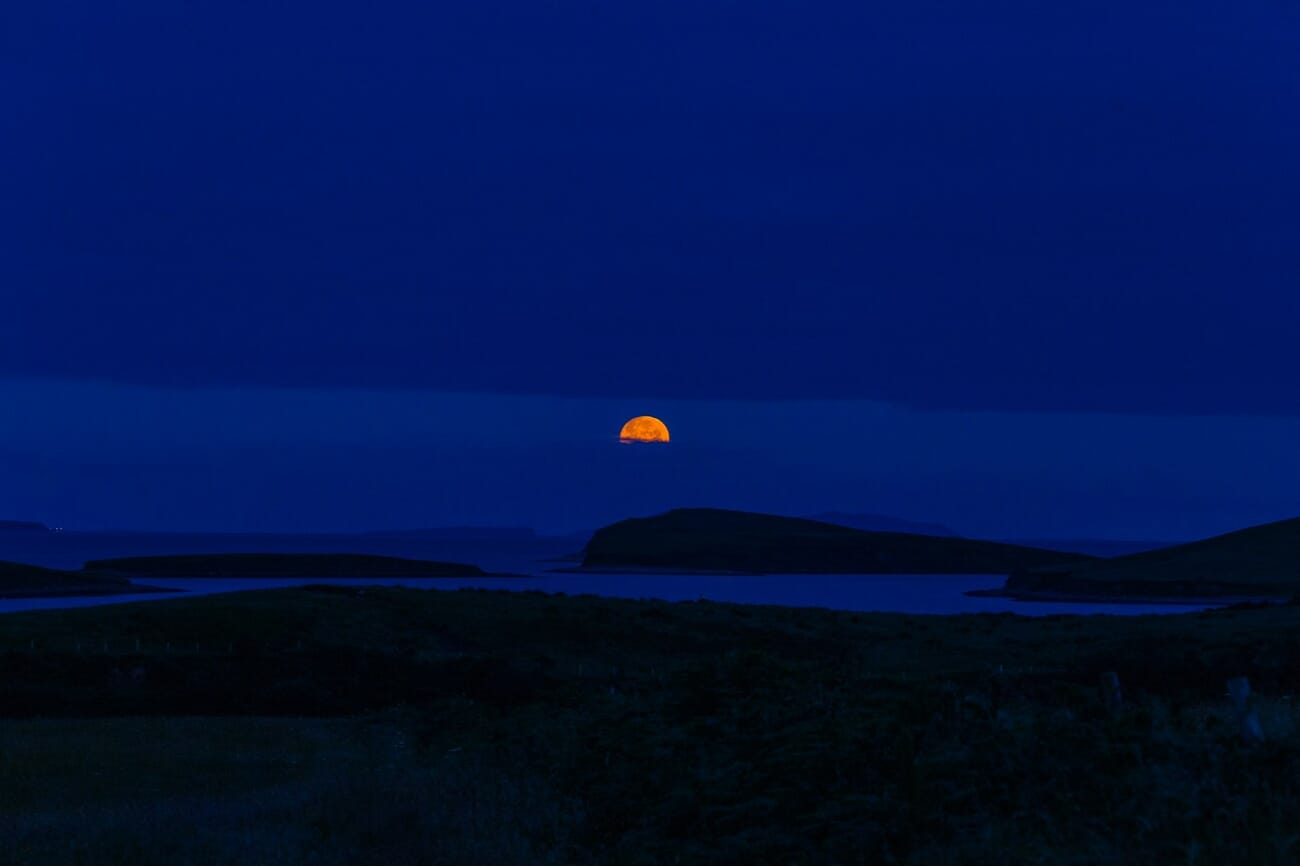 Deep blue twilight seascape at blue hour, an example of a cool color scheme in photography