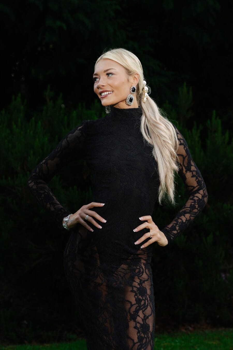 Woman photographed at a three-quarter angle showing how the angled body creates a slimmer, more dynamic silhouette