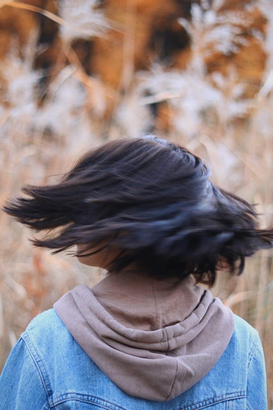 Woman with her hair blowing in the wind creating a dynamic natural movement in the photo