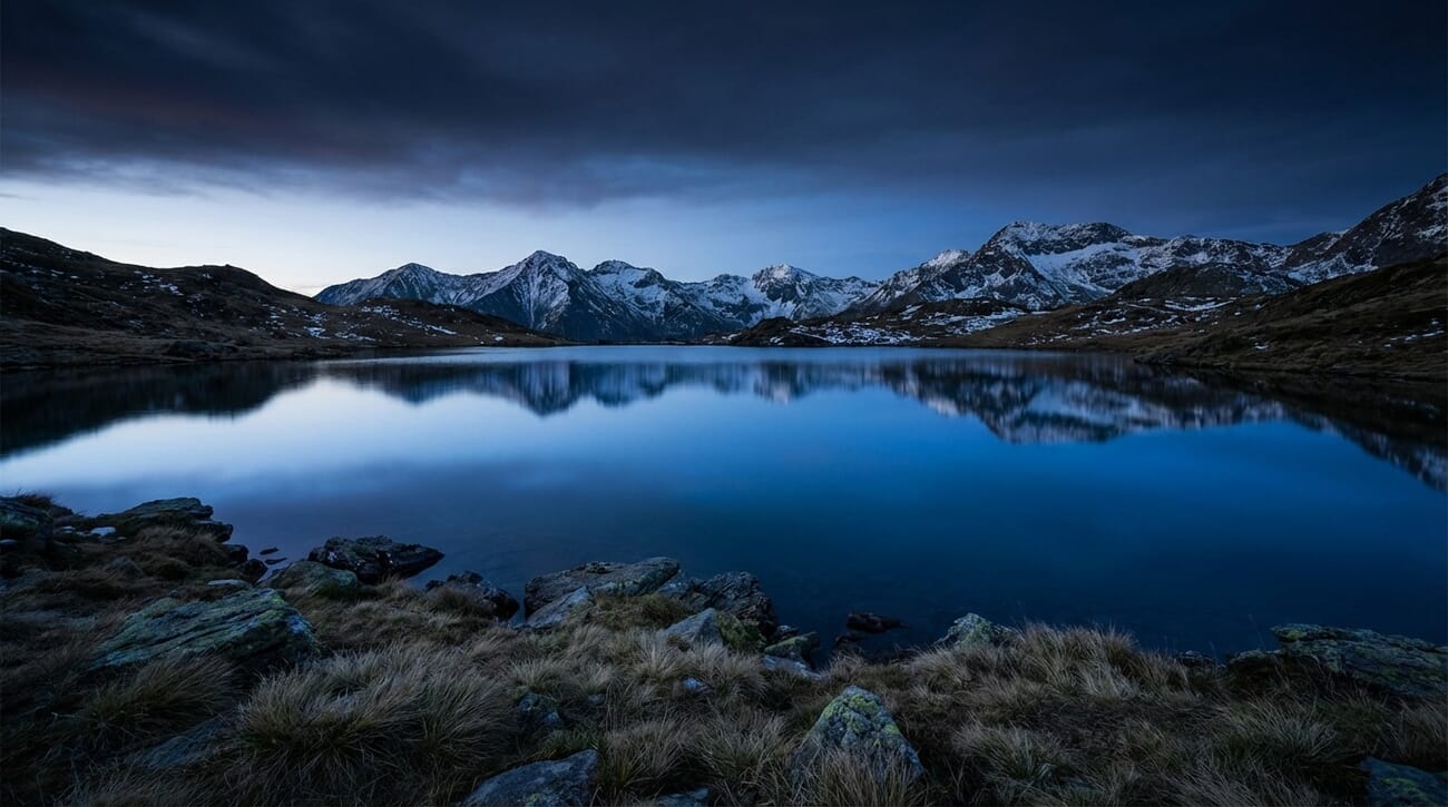 Mountain lake at blue hour with graduated filter effect — darker sky and brighter foreground