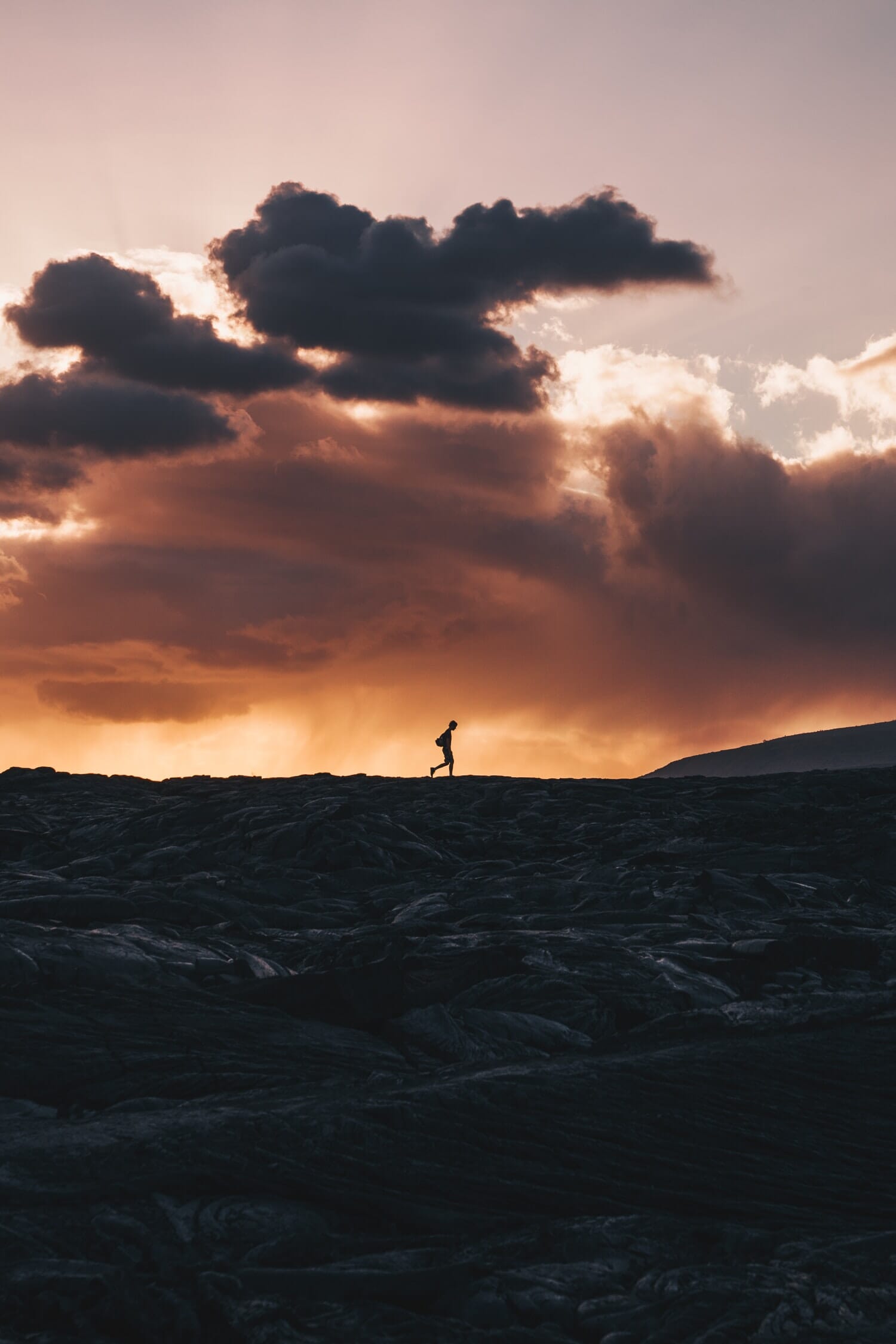 Man walking on a hill in the far.