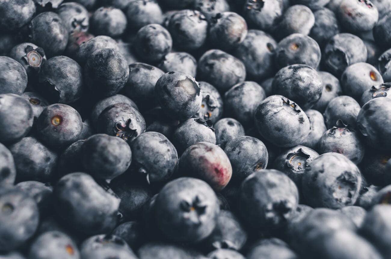Close-up food photography of fresh blueberries showing texture and color detail