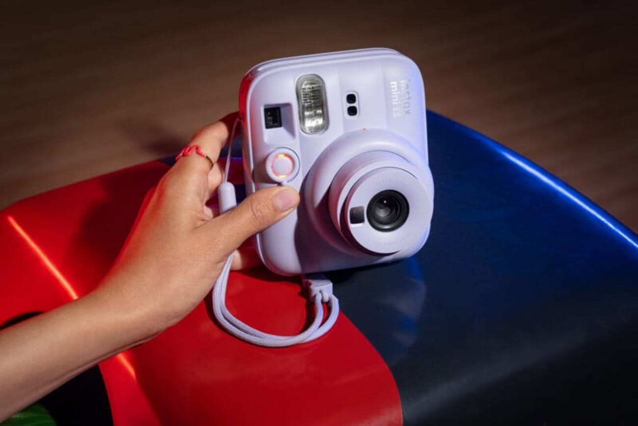 Fujifilm Instax Mini 13 in Dreamy Purple held in hand showing new sculpted design