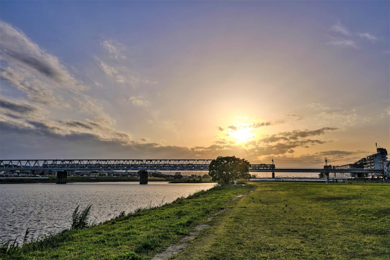 Golden hour river scene with a bridge creating diagonal composition