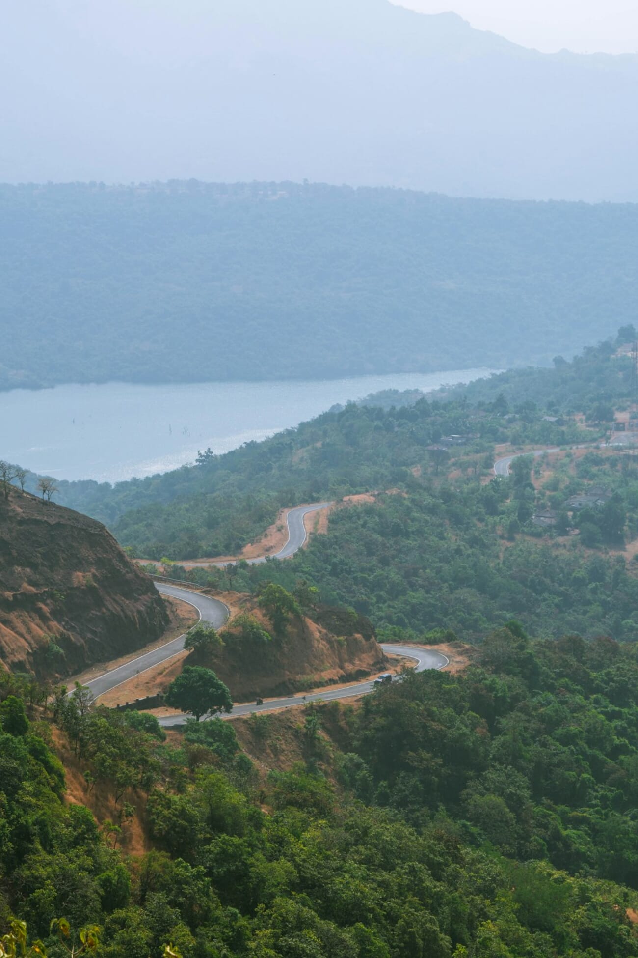 Winding mountain road demonstrating diagonal composition through misty hills