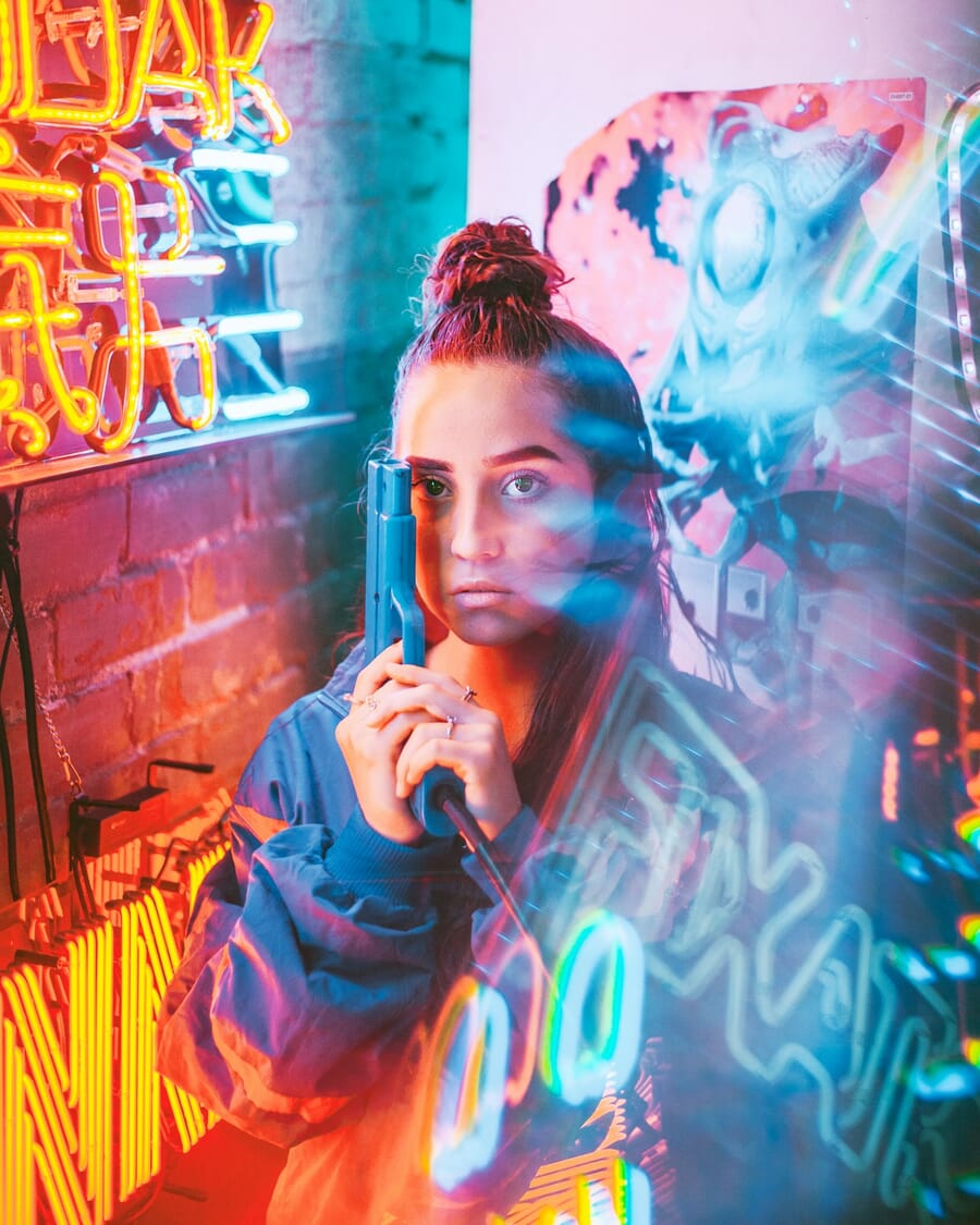Creative neon-lit portrait of a person in an urban alley — portrait photography business can earn $35,000-$80,000 per year