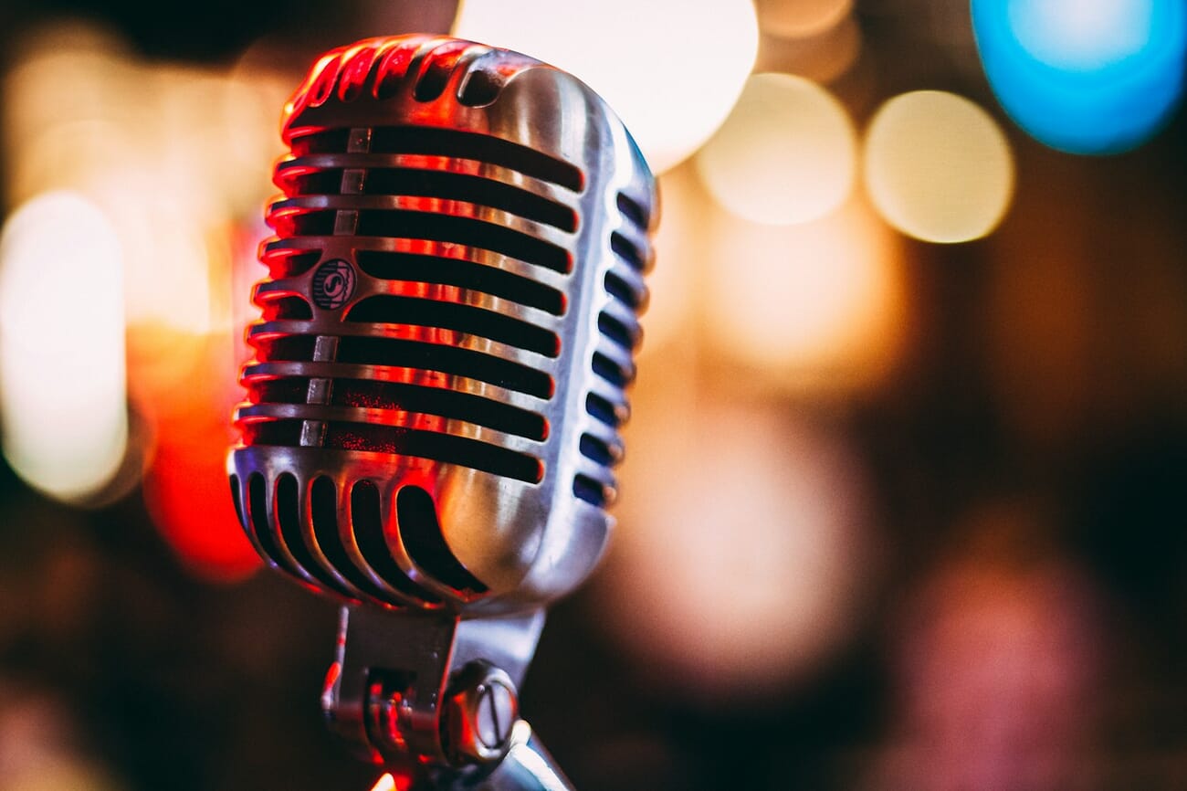 Vintage microphone on stage with bokeh lights in background
