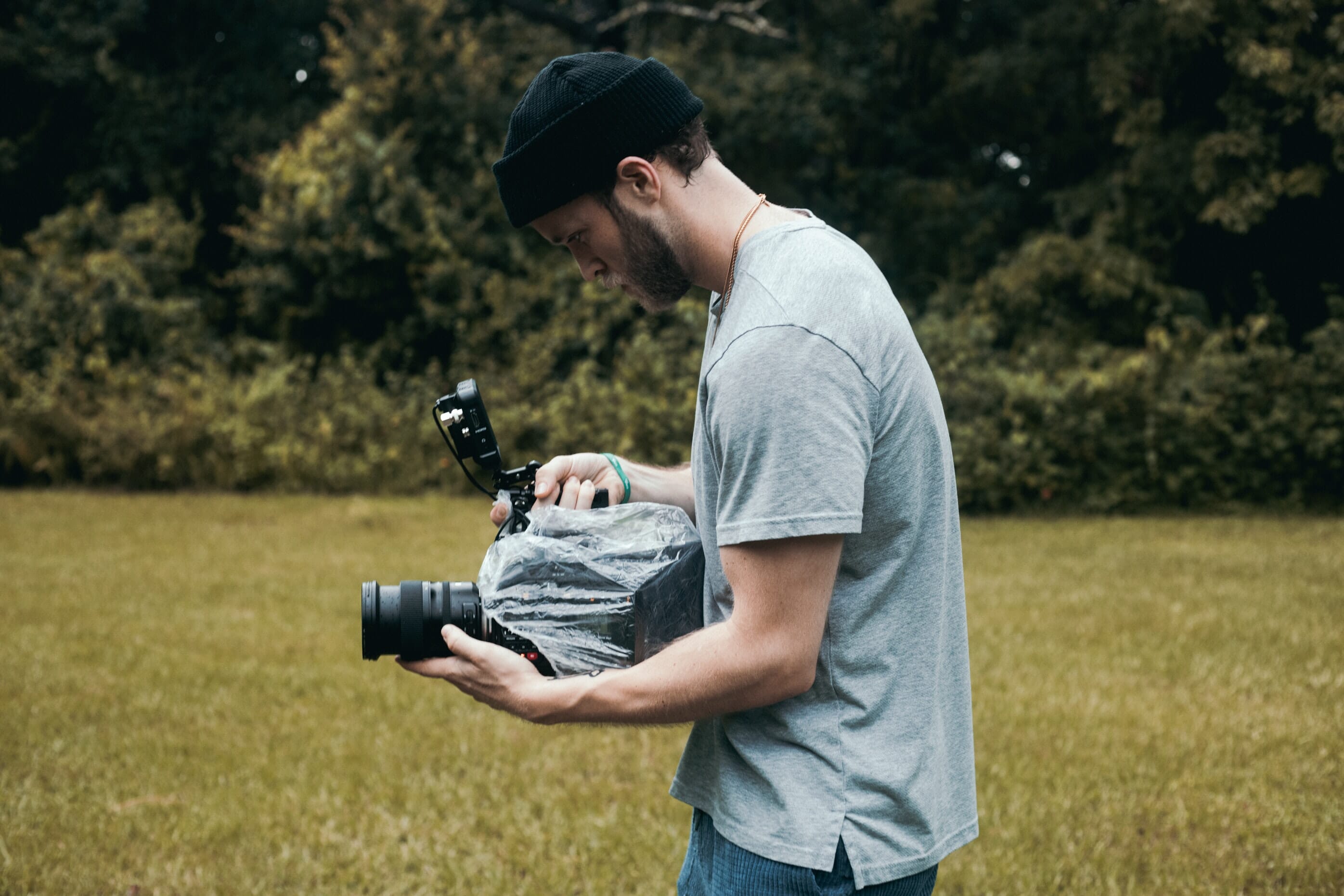 man with camera and rain cover
