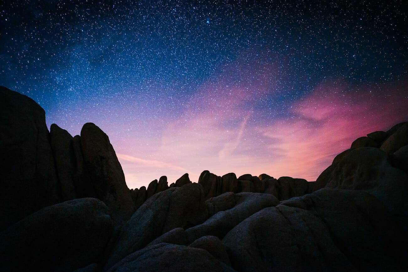 The Milky Way rising over granite silhouettes under a dark sky
