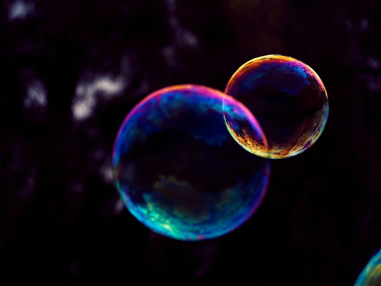 Macro close-up of a soap bubble showing iridescent swirling color patterns