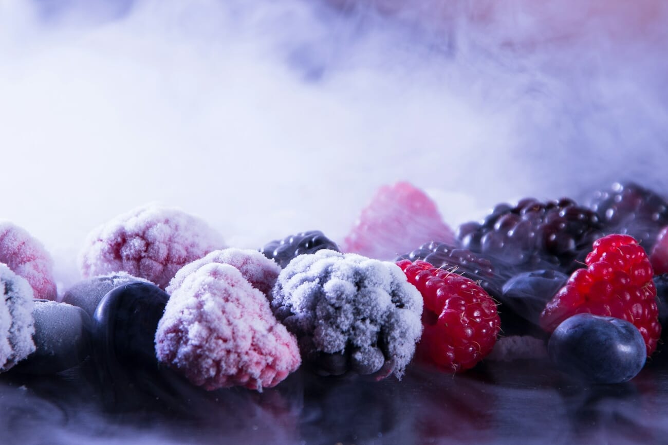 High-speed frozen-motion photograph of a strawberry or fruit splashing into water