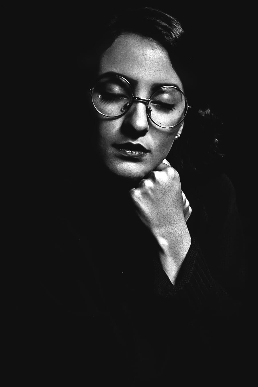 Woman with glasses photographed using loop lighting technique
