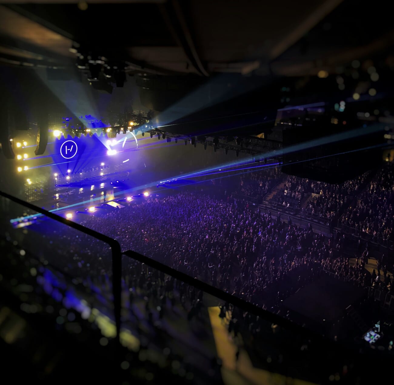 high-ISO concert scene — Laser Arcs Over a Packed Neon Arena
