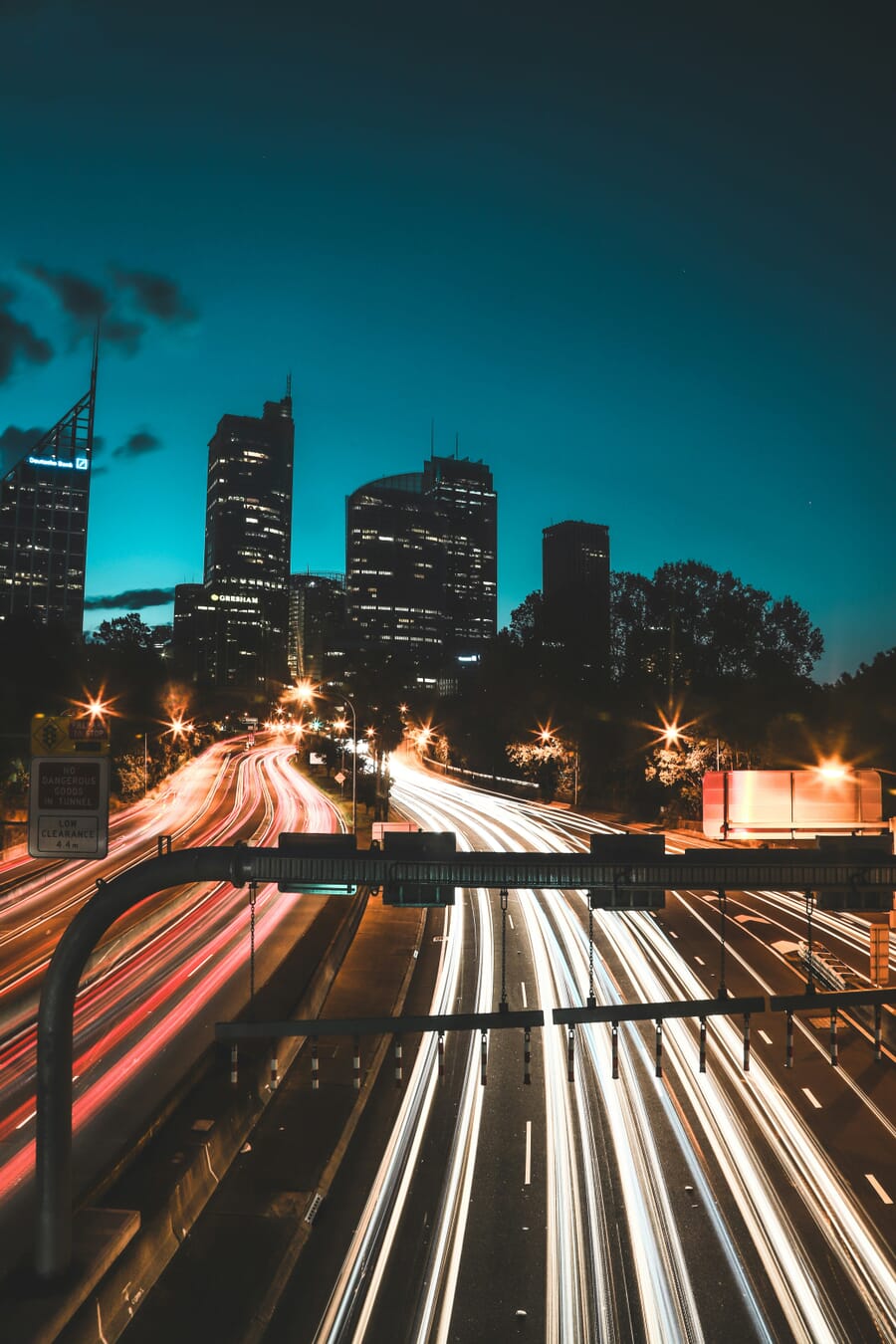 long shutter speed cityscape at night — Neon Arteries: Long-Exposure Night Over Downtown Freeway