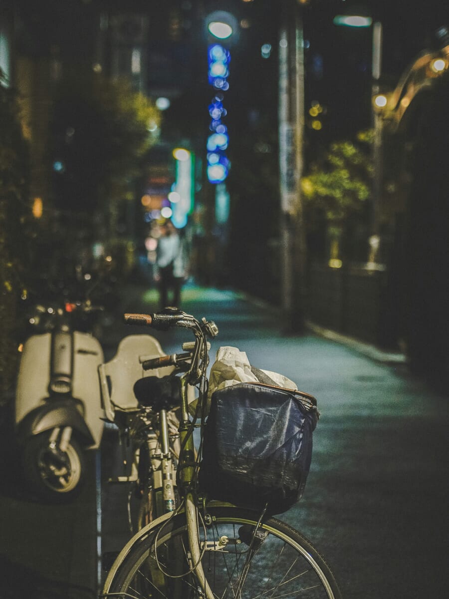 sharp street photograph at night — Neon-Lit Stroll: A Front-Basket Bicycle in Twilight Alley