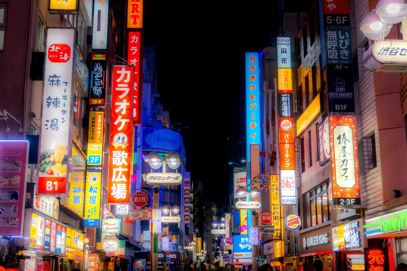 Neon Spine: A Night Street Framed by Floating Signboards