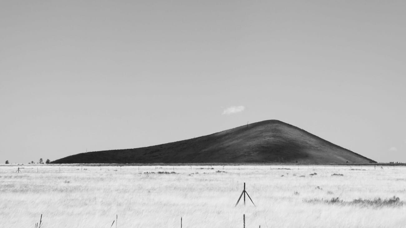 landscape photographer using a tripod at sunset — Dome Hill and the Silent Tripod