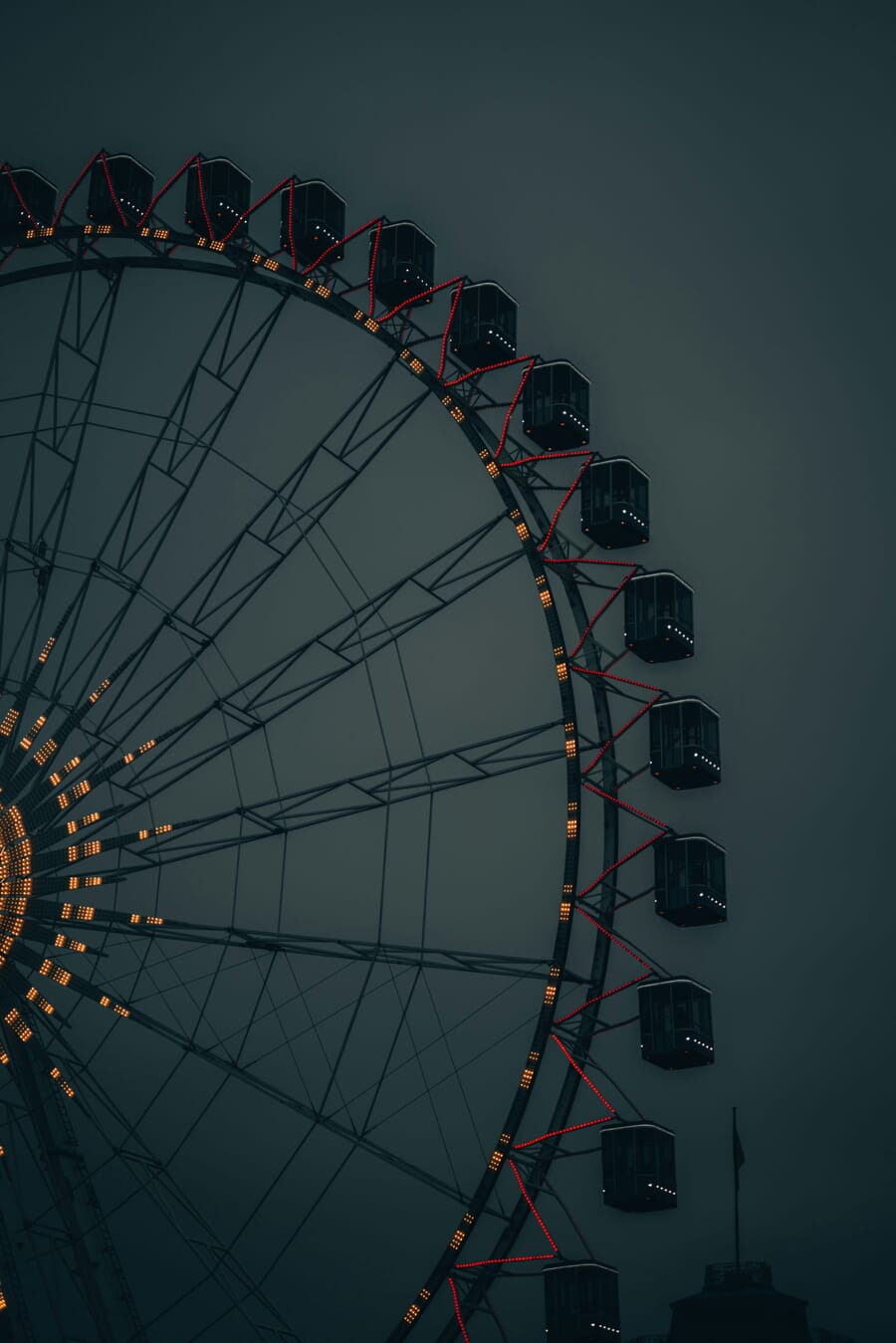 moody atmospheric low light photograph — Red-Spoked Arc: A Moonlit Ferris Wheel in Quiet Blues
