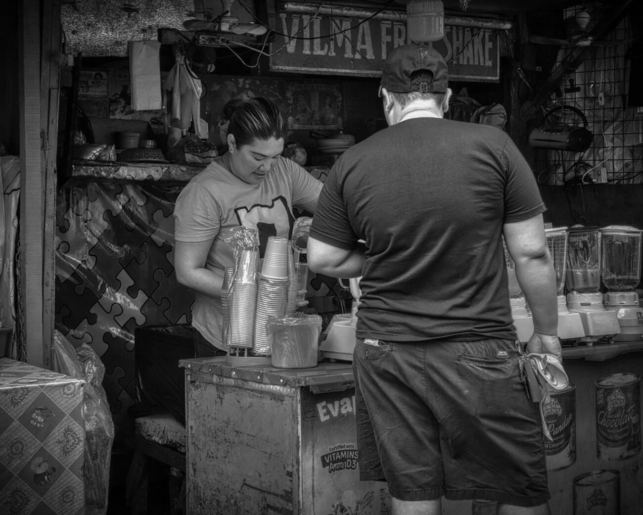 Fruit-Drink Stand: Woman Serves a Customer at a Street Kiosk