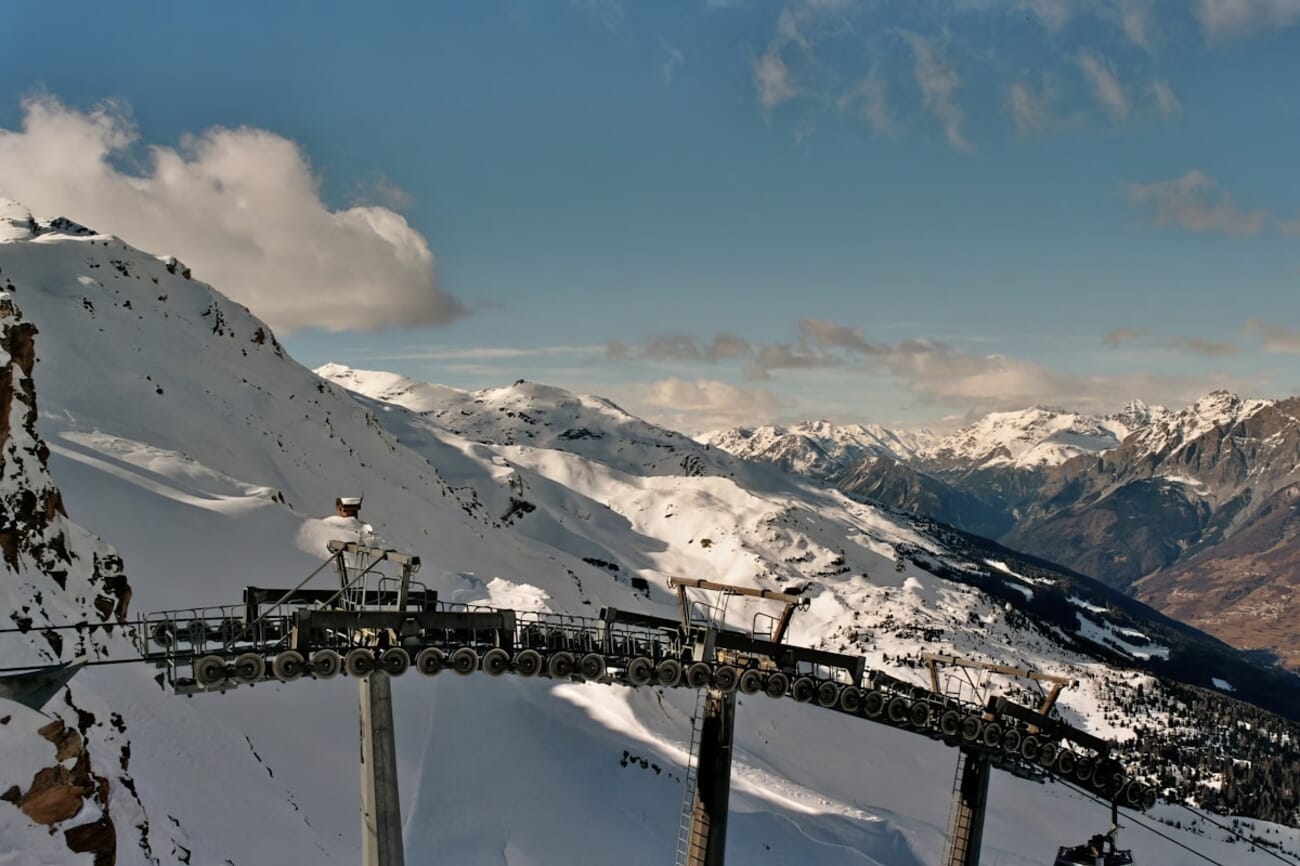 Ski lift ascending snow-covered mountains — shot on Minolta Dynax 303si