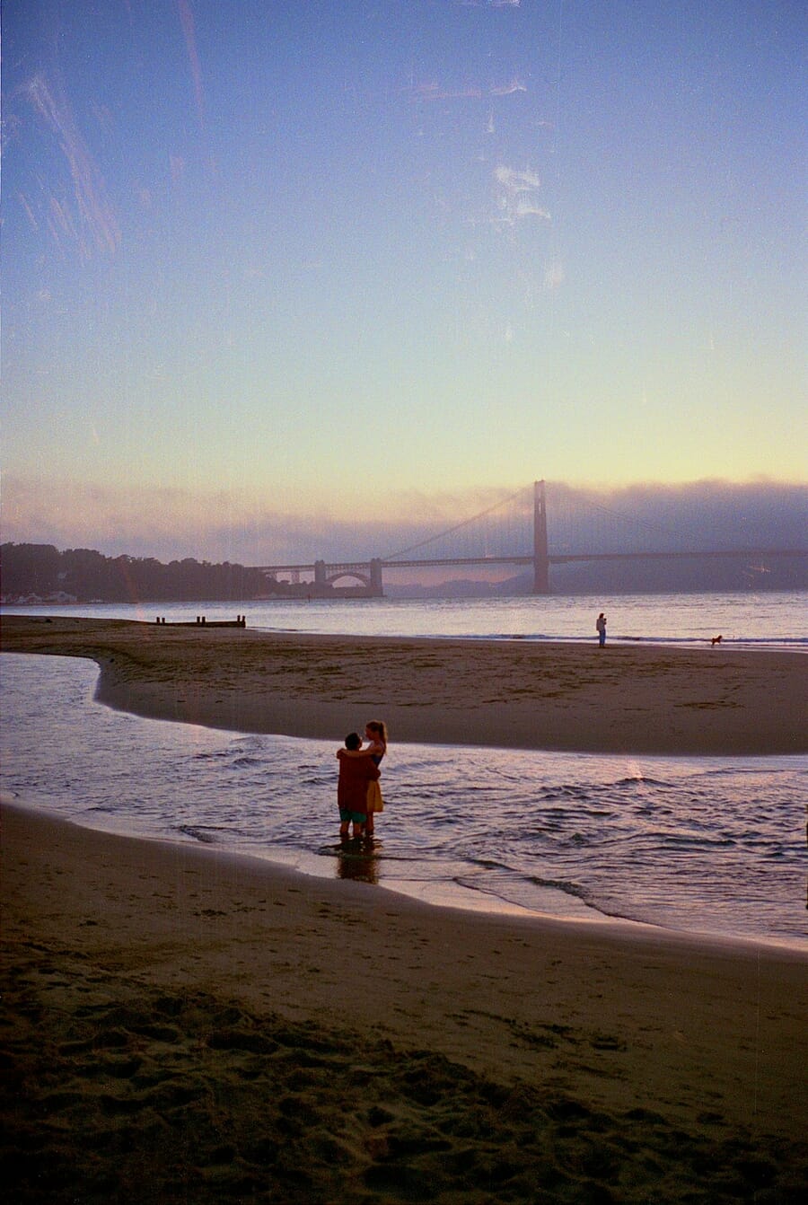 Couple embracing at twilight with Golden Gate Bridge — shot on Minolta TC-1