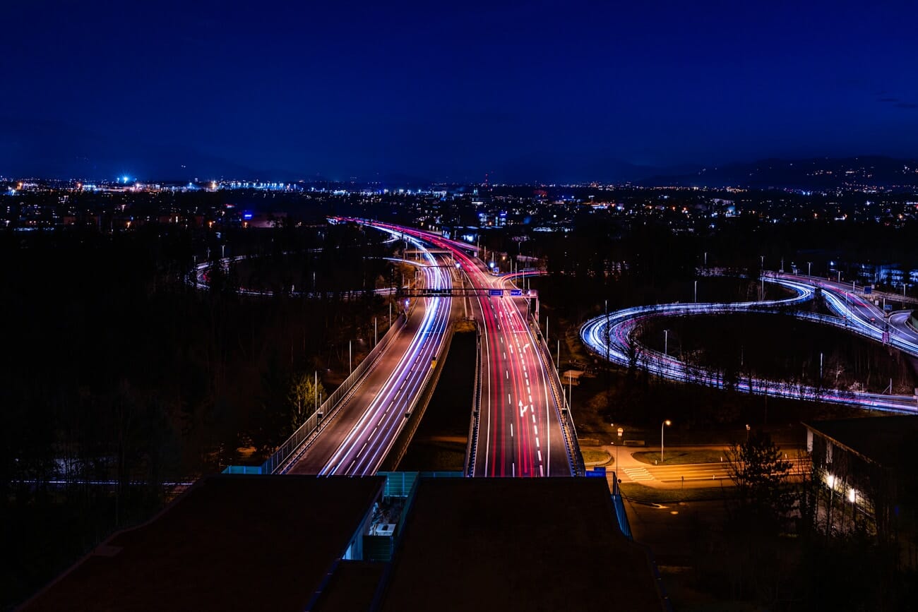 Car light trails streaming along a highway at night — long exposure photography