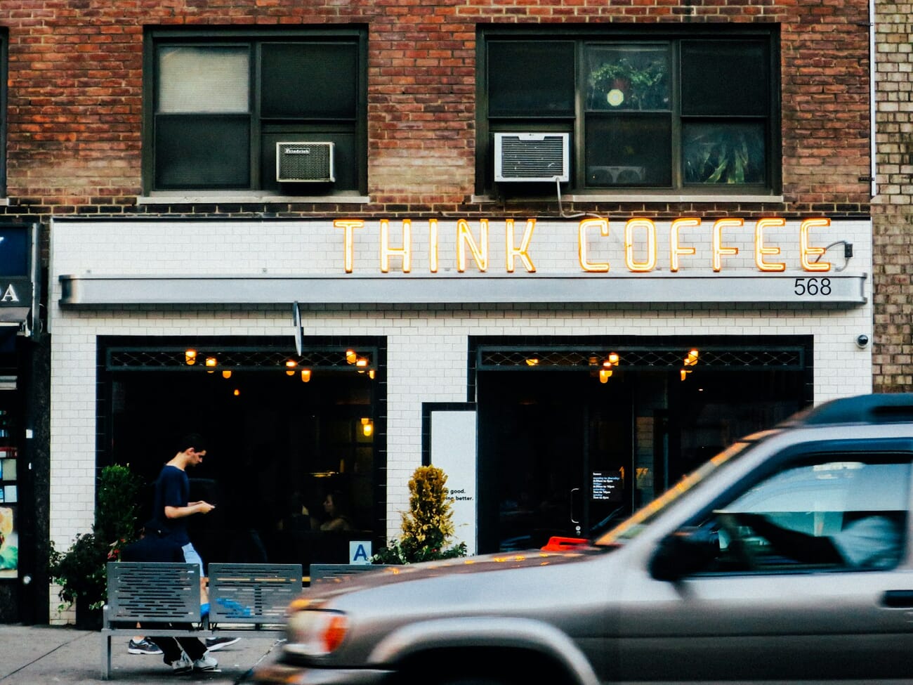 A brick café storefront on a West Village street in Manhattan