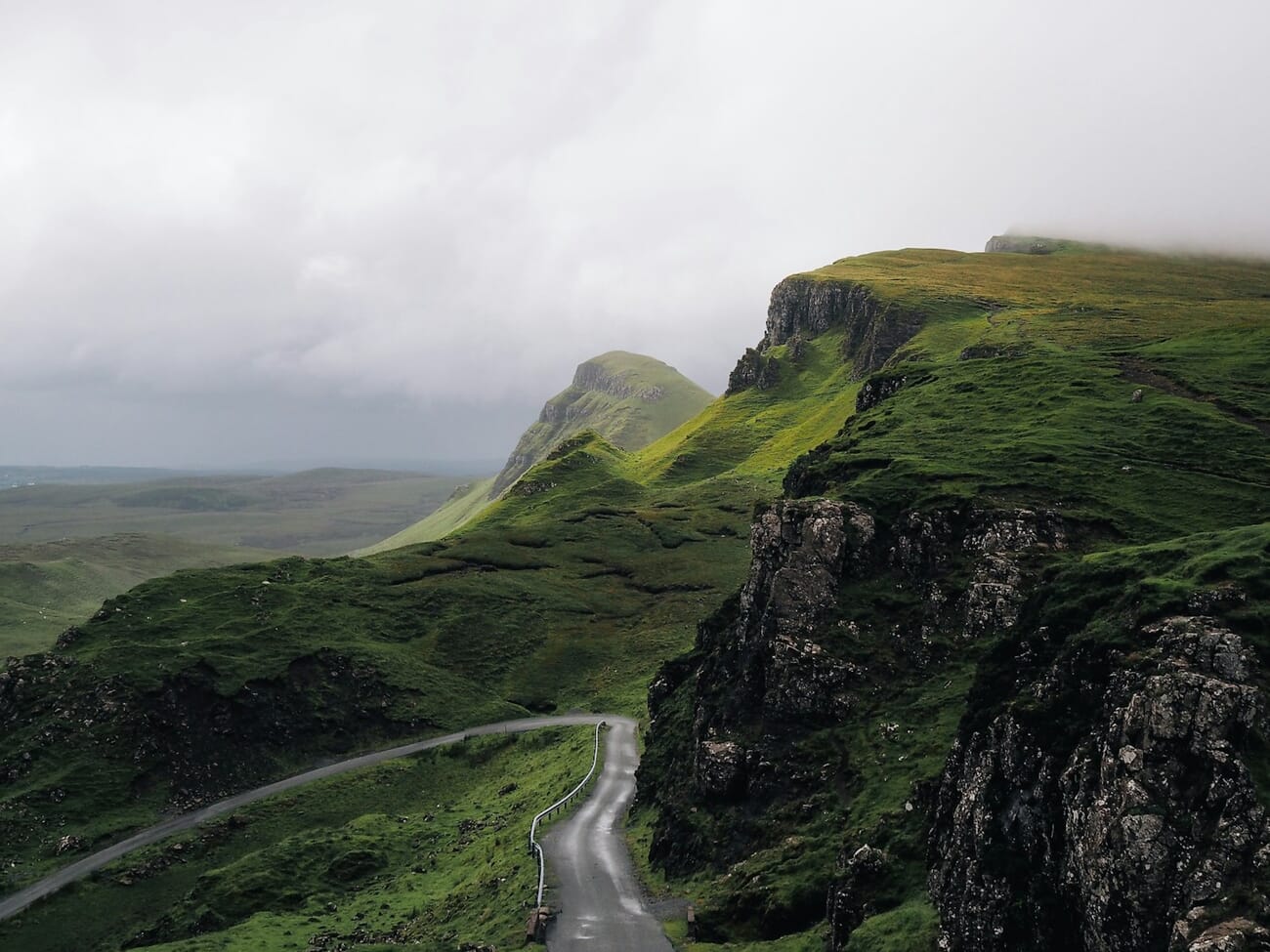 Misty road through green highland landscape demonstrating rule of thirds composition