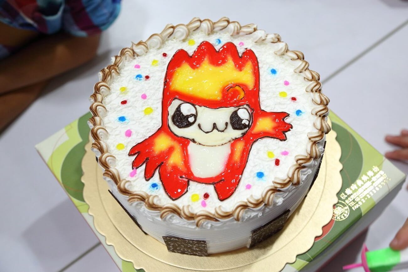 Colourful birthday cake with a playful design and lit candles