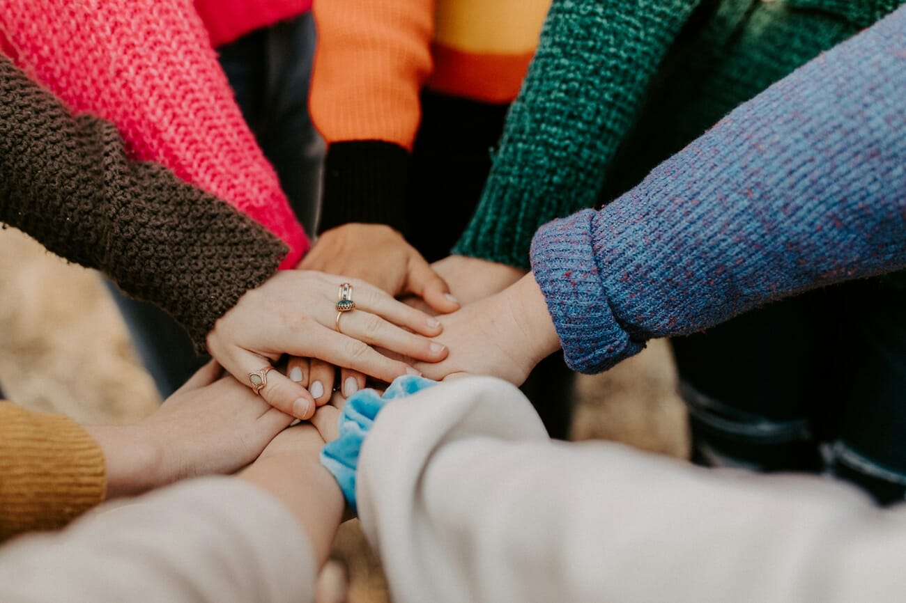 Diverse hands joined together showing community and connection