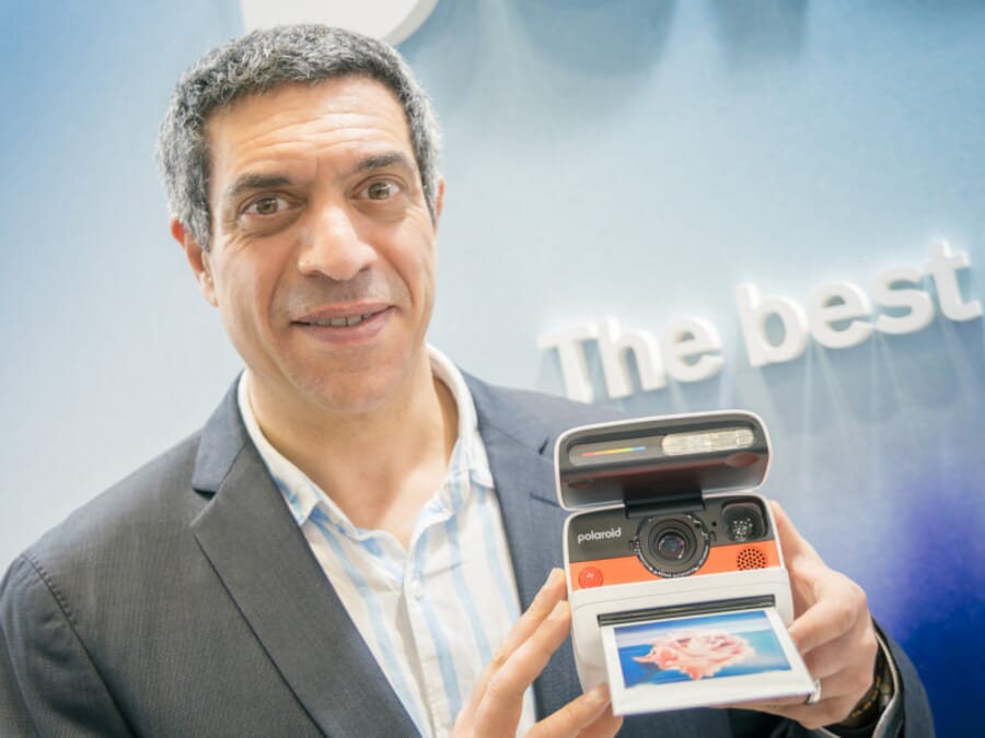 Dan Dossa, CEO of Polaroid, holding an instant camera at CP+ 2026