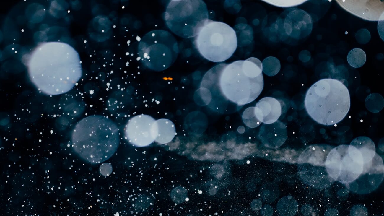 Out-of-focus highlights dissolving into creamy circular bokeh against a dark background, shot at f/3.2 · 1/60 · ISO 3200