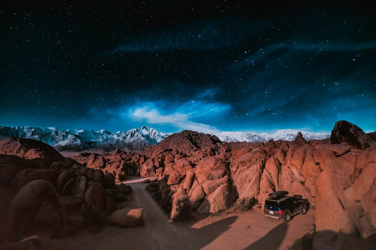 Rock formations flanking a winding road, the whole scene sharp from foreground to distance, shot at 13s · ISO 6400
