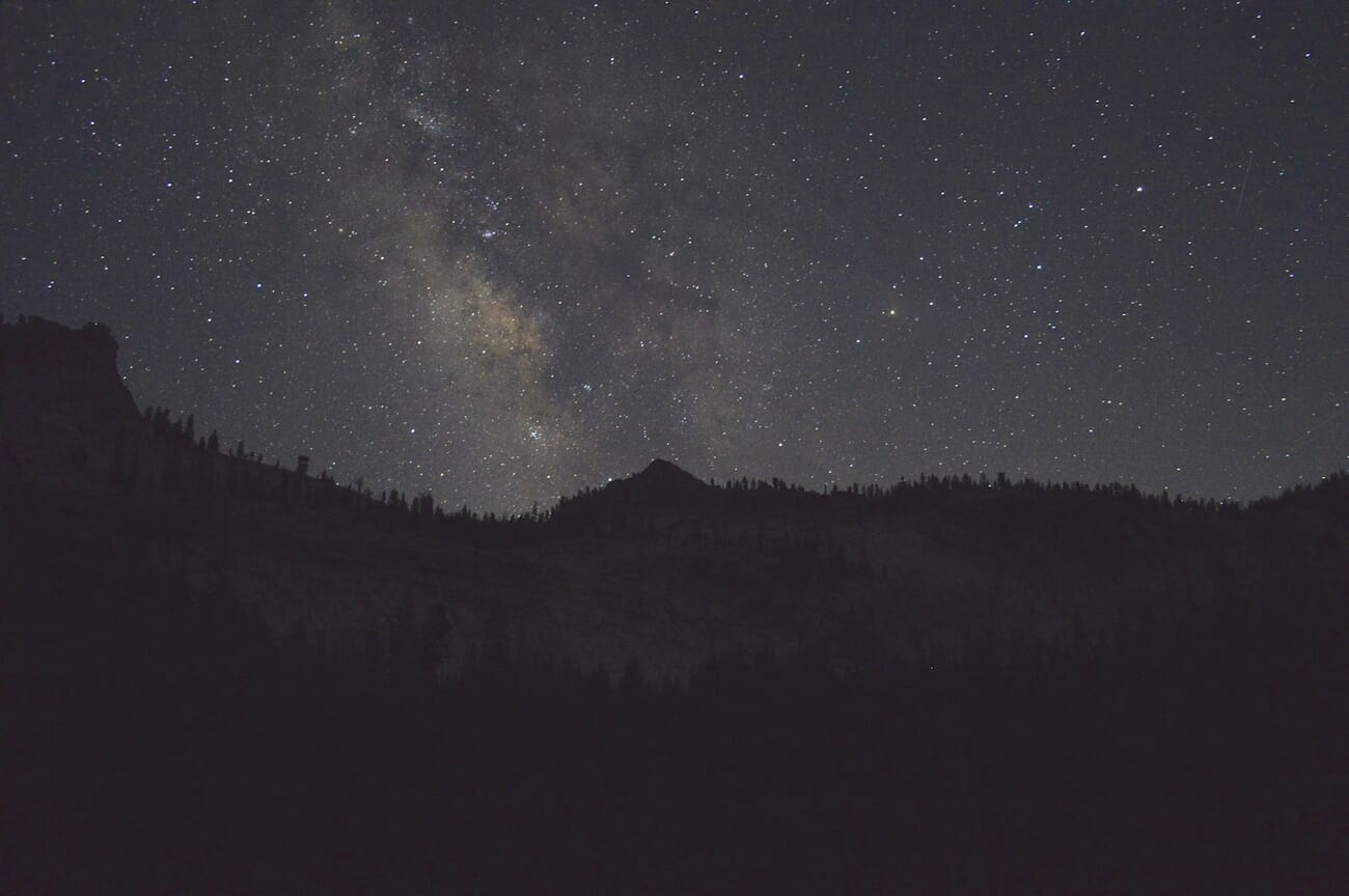 The Milky Way arching over a dark ridgeline, thousands of stars resolved cleanly in a high-ISO astro exposure, shot at f/3.5 · 20s · ISO 1600
