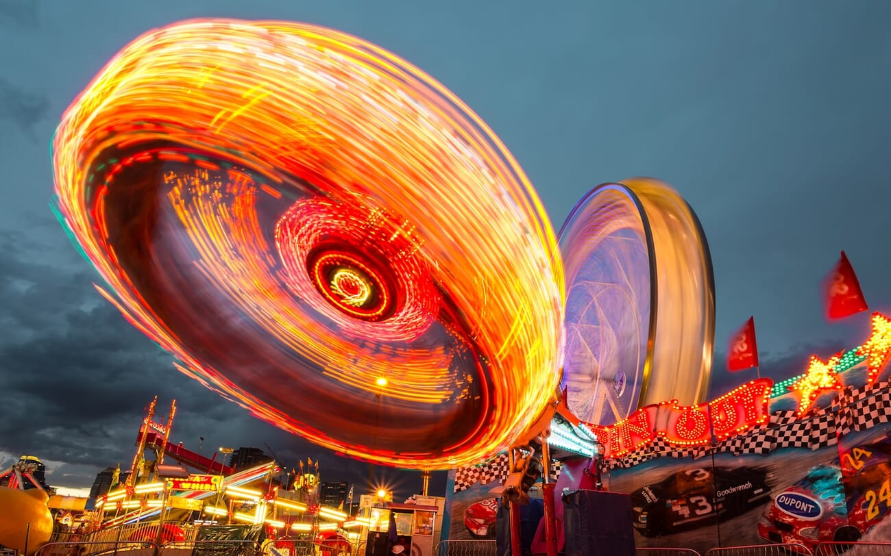 Carnival lights swirling into patterns of color from a long-exposure capture at night, shot at f/16.0 · 4s · ISO 100