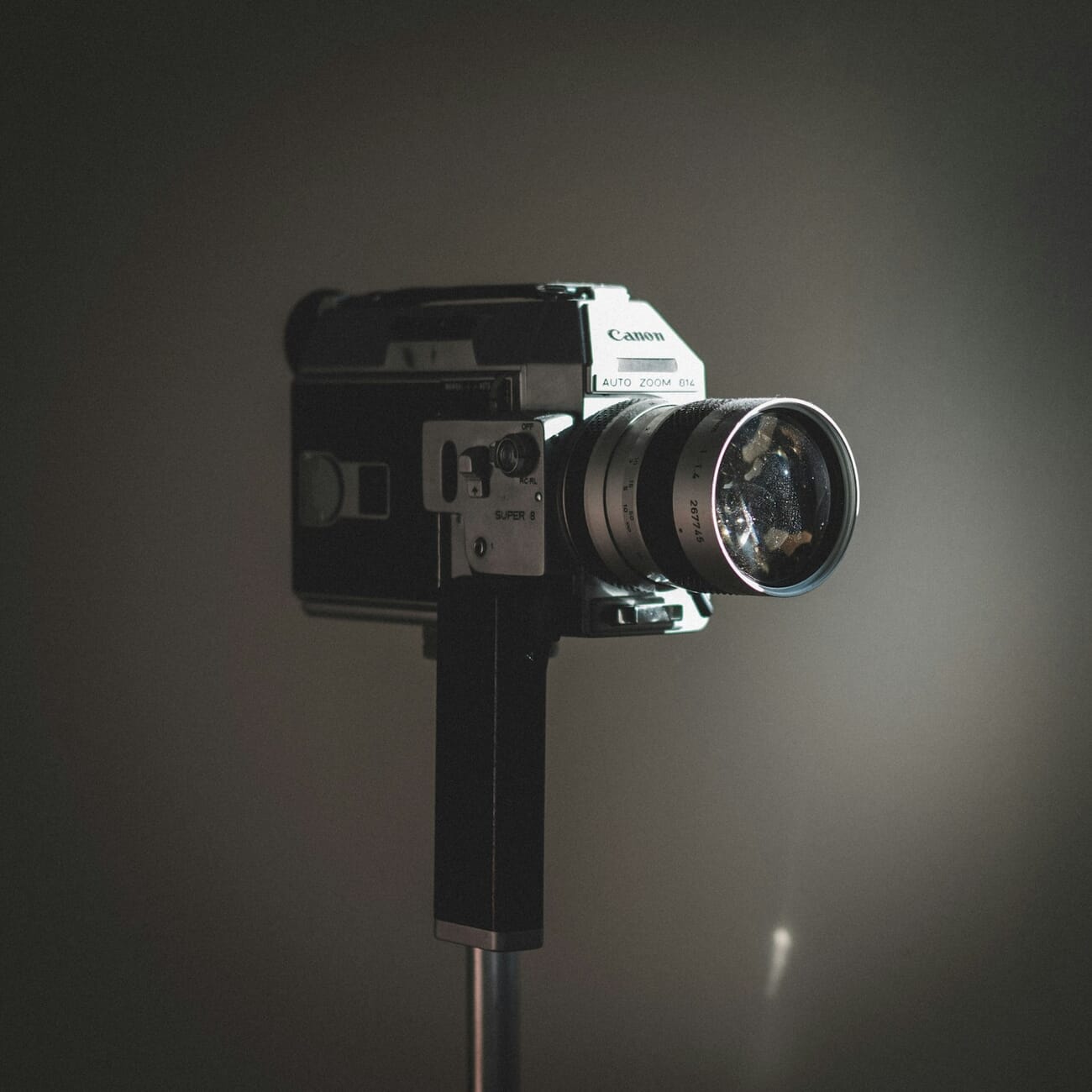 A vintage film camera photographed close-up, its manual controls and viewfinder visible in detail, shot at f/2.0 · 1/500 · ISO 100