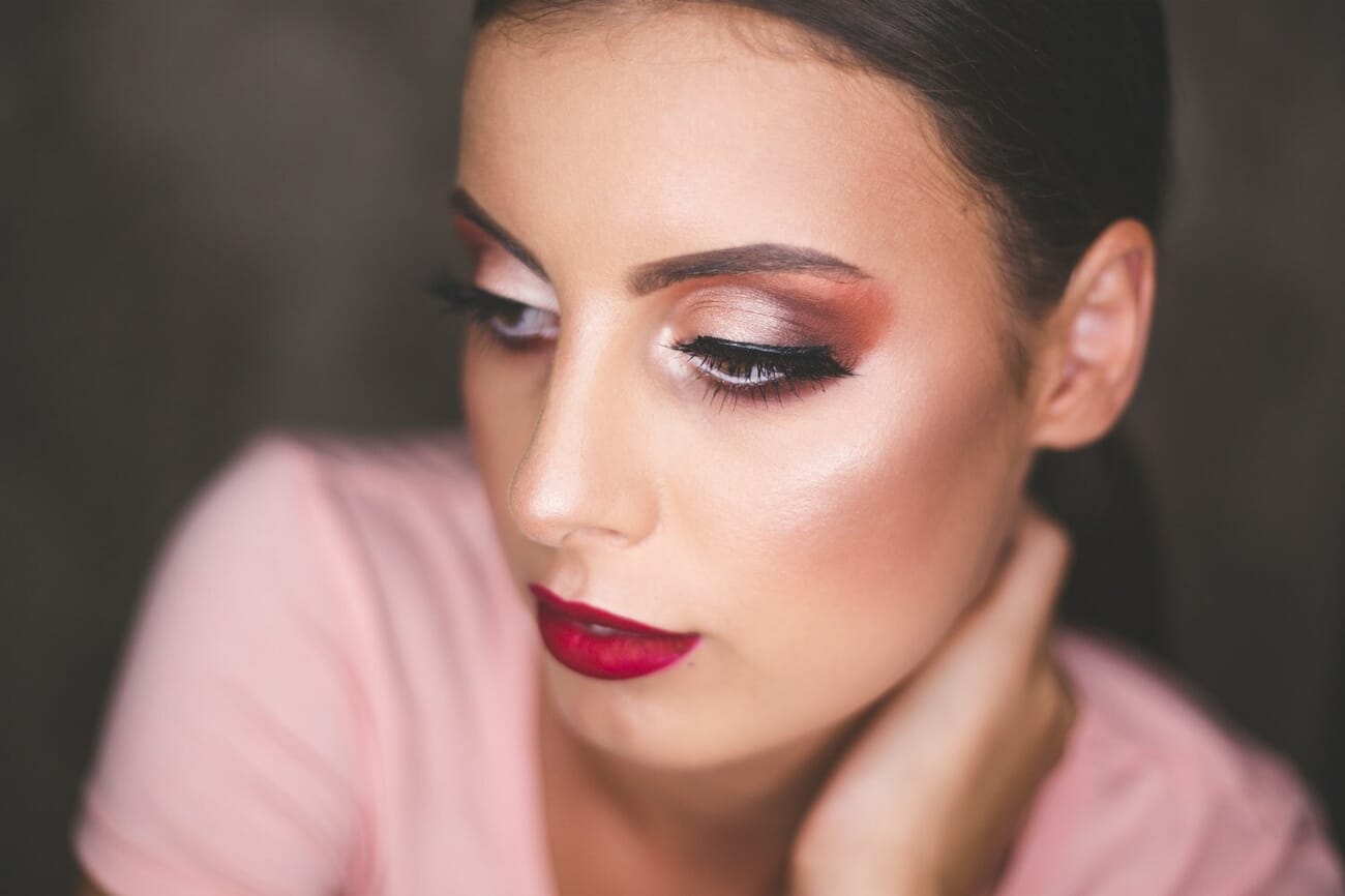 Close-up beauty portrait of a woman with red lipstick in studio lighting