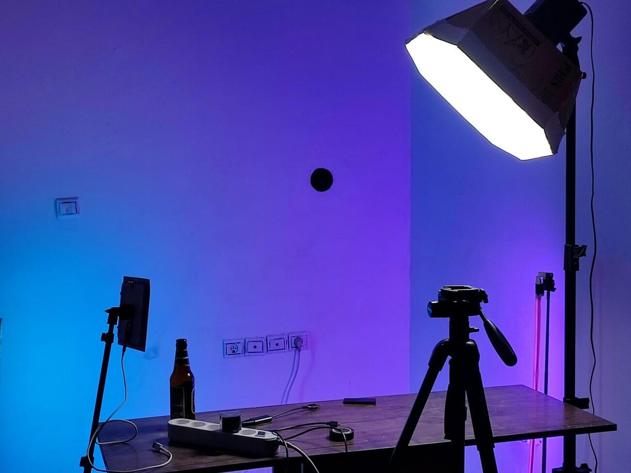 Photography studio setup with professional lighting equipment and camera on tripod