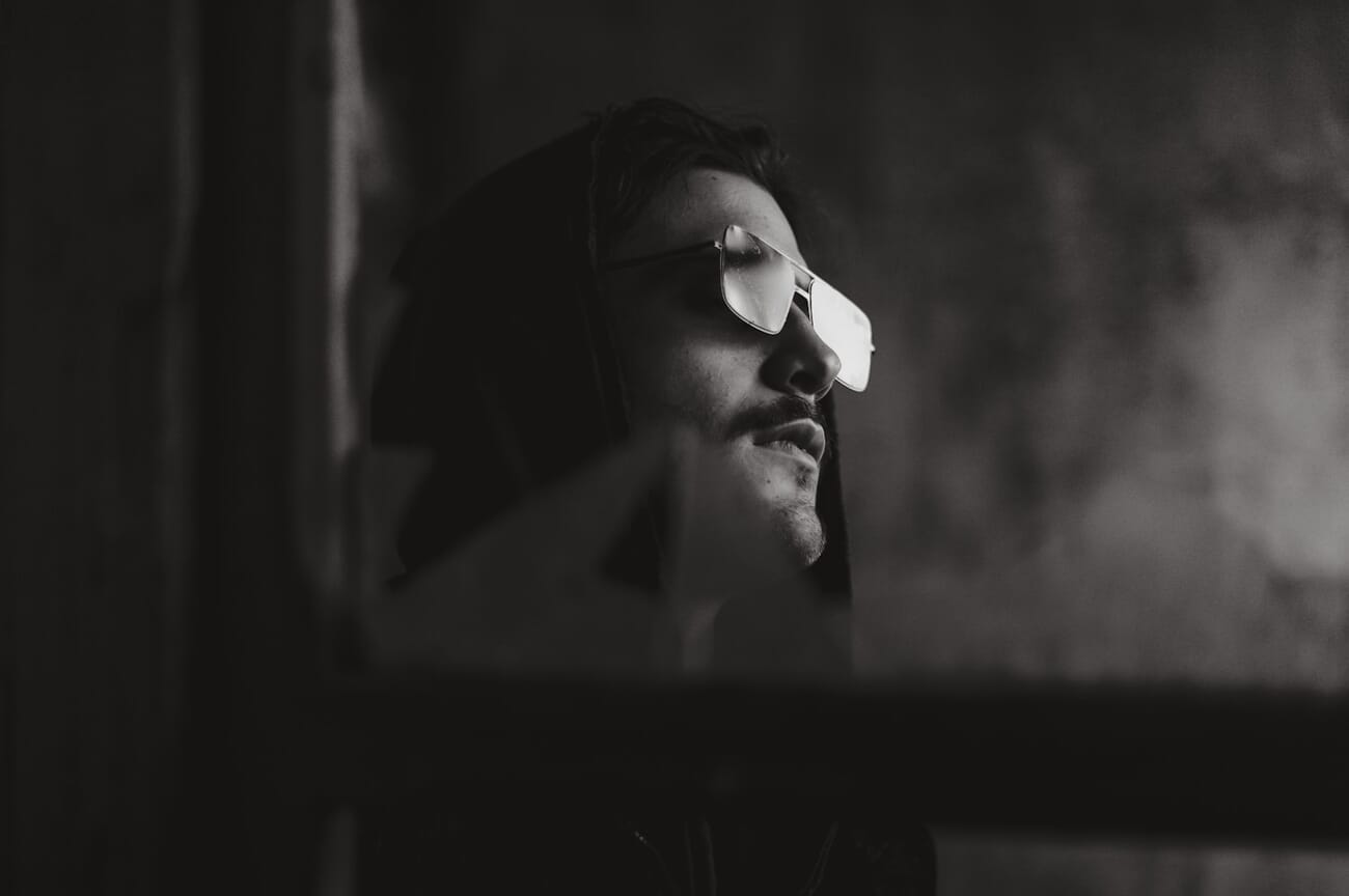 Dramatic black and white portrait of a man wearing sunglasses shot on Nikon D700