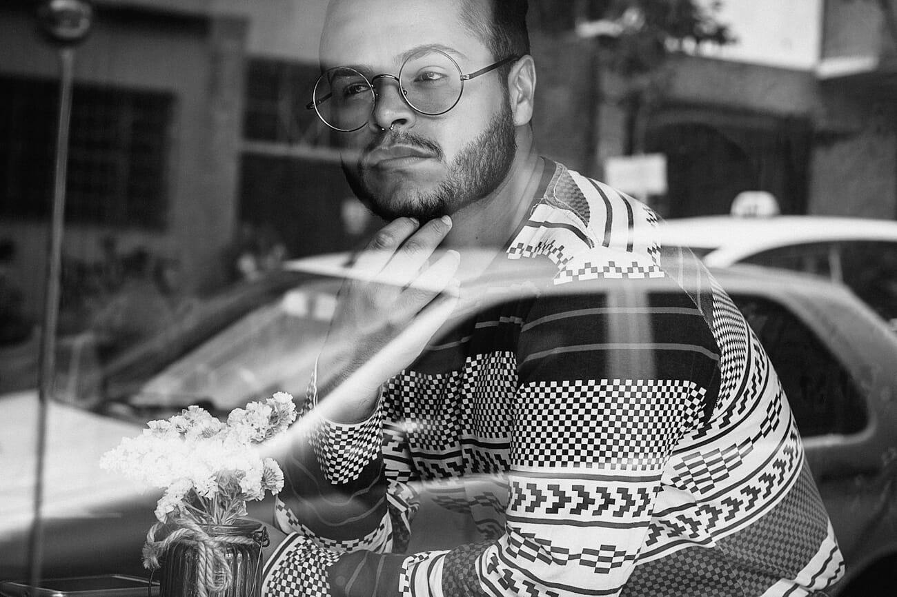 Man looking out window with dramatic side lighting, shot on Canon EOS 70D