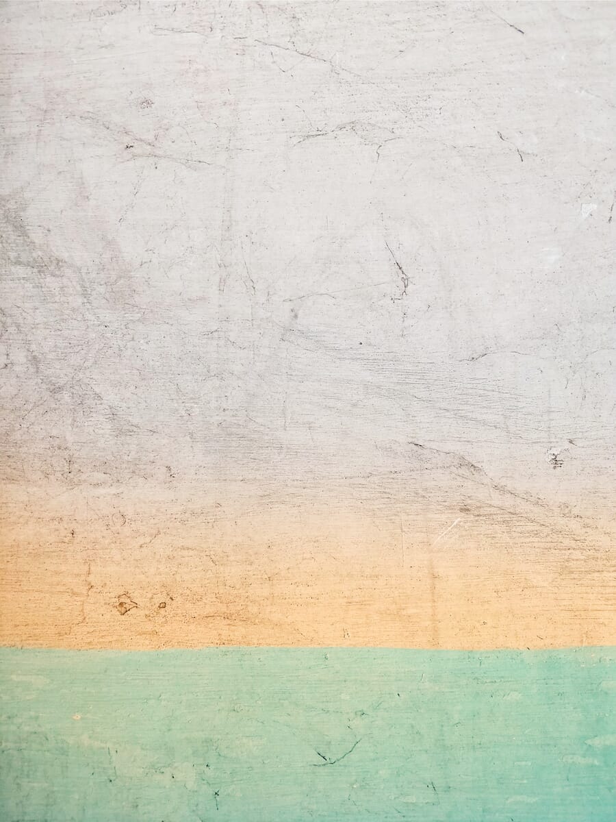 Textured wall with colorful horizontal bands showing surface depth and variation