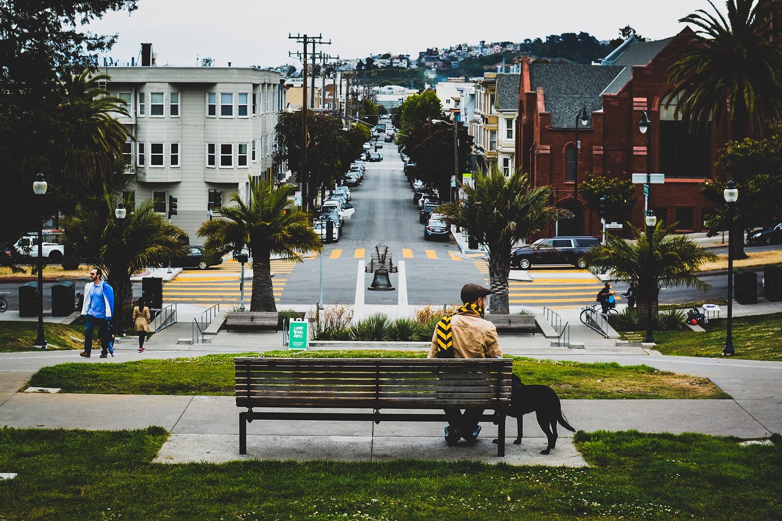 Candid urban portrait shot of a man sitting at a park bench