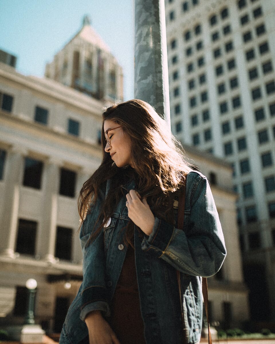 woman surrounded by buildings