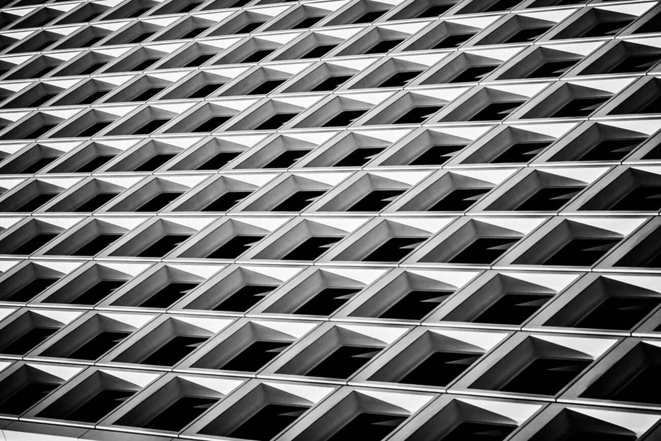 Repeating diamond pattern on a modern building facade in black and white