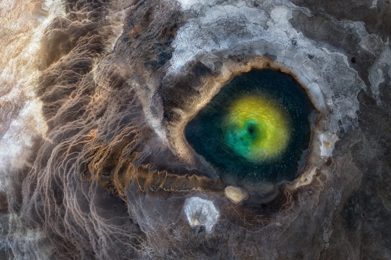 The Eye of the Dragon - aerial drone shot of geothermal pool in Iceland by Miki Spitzer